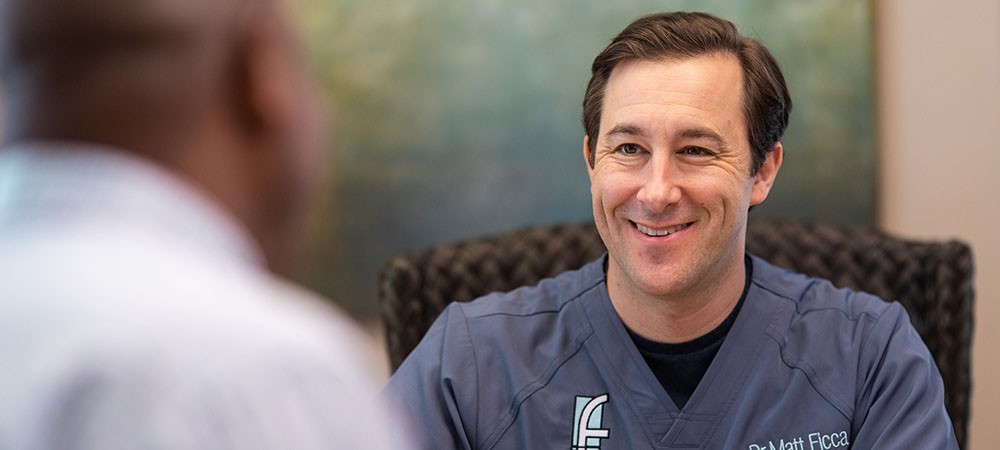 Dr. Ficca smiling at a male patient