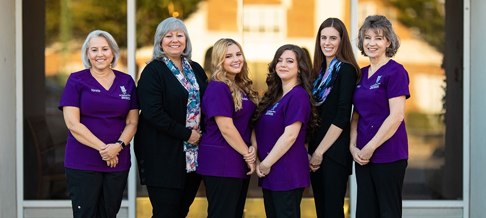 A group photo of the Metrolina Periodontics dental staff