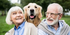 Smiling Old Couple with a Dog in Between