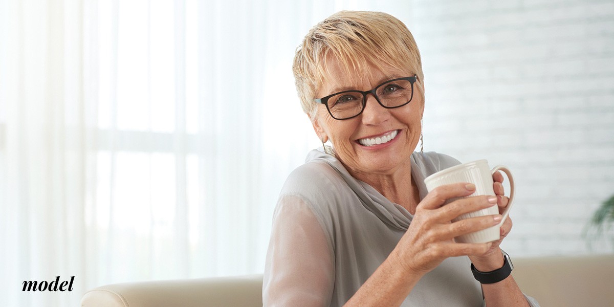 Older Female With Dentures Drinking from Mug